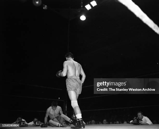 Photo shows Al Andrews knocked down in the fifth round by Gustav Scholz of Berlin, Germany. Scholz was awarded an unanimous decision outpointing...