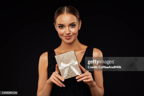 young beautiful woman with perfect hair holding a gift container - glamour presents stock pictures, royalty-free photos & images