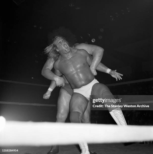 International Wrestling Title event featuring Hulk Hogan and Andre Giant. Pictured here is Andre Giant grabing both of Hogan's arms and pulling them...