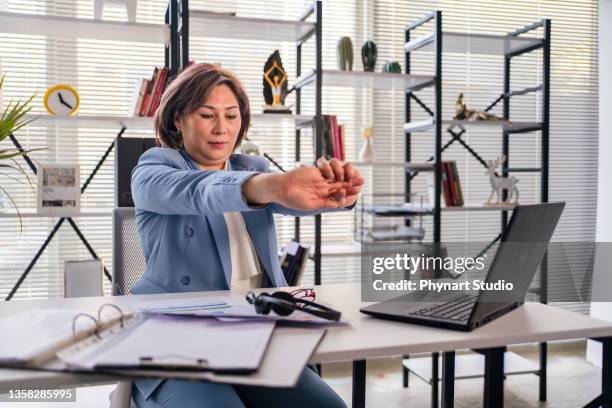 woman stretching while working from a  office - design studio woman chinese laptop bildbanksfoton och bilder