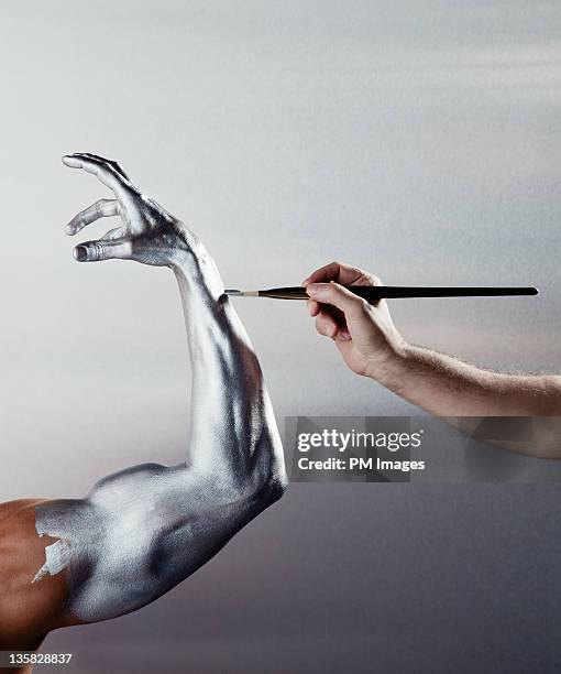 painting man's arm silver - perfect fit photos et images de collection