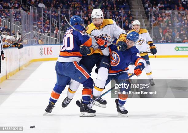 Filip Forsberg of the Nashville Predators attempts to get past Kieffer Bellows and Jean-Gabriel Pageau of the New York Islanders at the UBS Arena on...