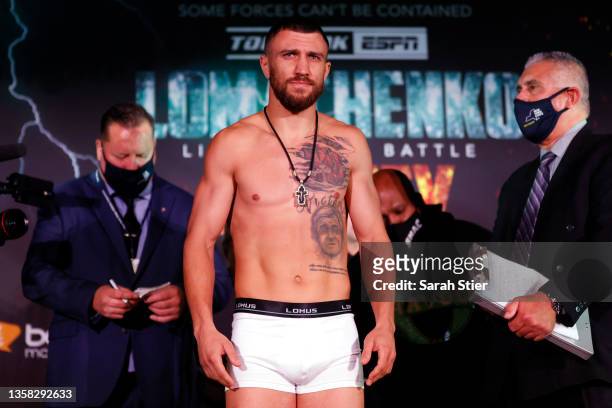 Vasiliy Lomachenko of Ukraine poses on the scale during the official weigh-in prior to his WBO Intercontinental Lightweight bout against Richard...