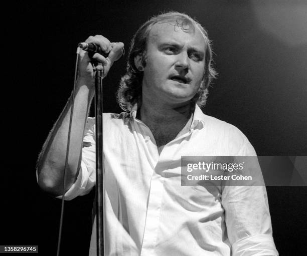 English drummer, singer, record producer, songwriter, and actor Phil Collins, of the English rock band Genesis, sings on stage during a concert circa...