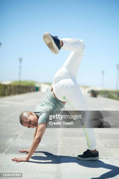 shot of a young woman dancing while out in the city - all hip hop models stock pictures, royalty-free photos & images