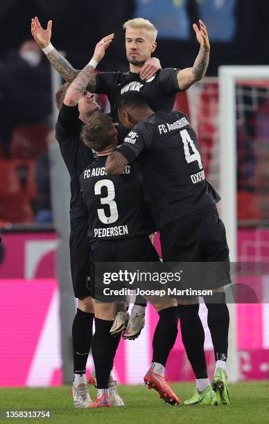 Niklas Dorsch of Augsburg celebrates scoring his team's second goal with his team mates during the Bundesliga match between 1. FC Köln and FC...