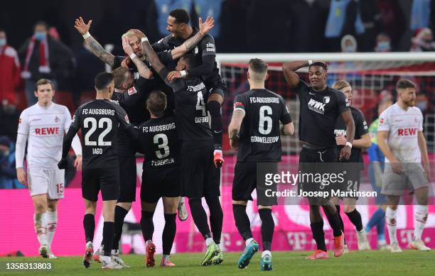 Niklas Dorsch of Augsburg celebrates scoring his team's second goal with his team mates during the Bundesliga match between 1. FC Köln and FC...
