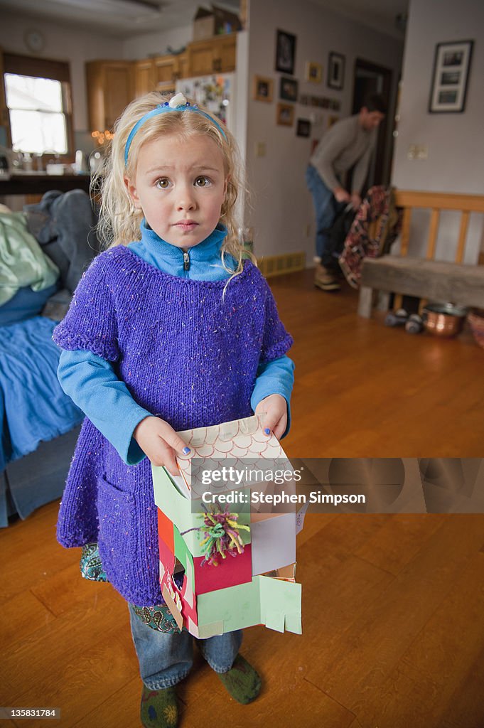 Small girl with house made from milk carton