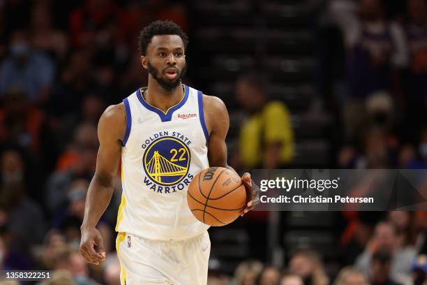 Andrew Wiggins of the Golden State Warriors handles the ball during the first half of the NBA game at Footprint Center on November 30, 2021 in...