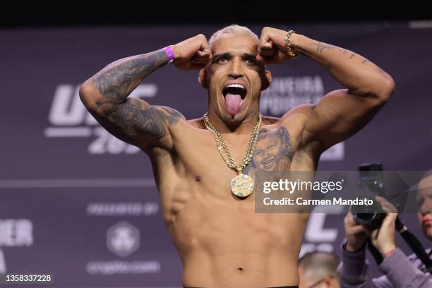 Charles Oliveira of Brazil reacts on stage alongside Joe Rogan during the UFC 269 ceremonial weigh-in at MGM Grand Garden Arena on December 10, 2021...
