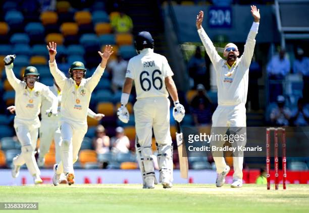 Nathan Lyon of Australia celebrates taking his 400th test wicket after dismissing Dawid Malan of England for 82 runs during day four of the First...