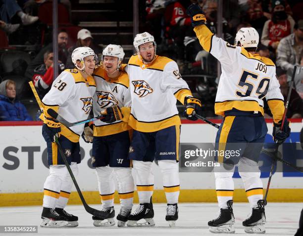 Eeli Tolvanen of the Nashville Predators is congratulated by teammates Mikael Granlund,Ryan Johansen and Roman Josi after he scored against the New...