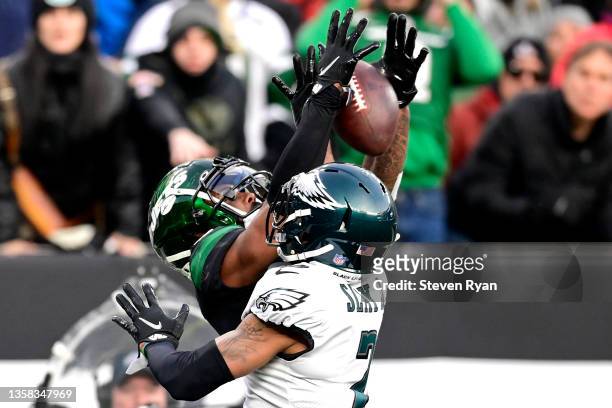 Darius Slay of the Philadelphia Eagles breaks up a pass intended for Elijah Moore of the New York Jets at MetLife Stadium on December 05, 2021 in...