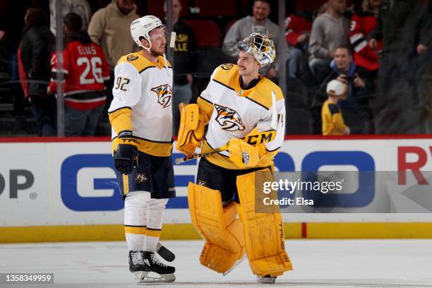 Ryan Johansen and Juuse Saros of the Nashville Predators celebrate the win over the New Jersey Devils during the third period at Prudential Center on...