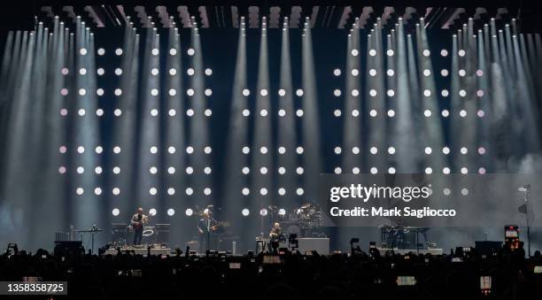 Mike Rutherford , Phil Collins and Tony Banks of Genesis perform in concert during the "The Last Domino?" tour at UBS Arena on December 10, 2021 in...