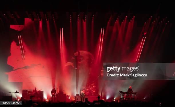 Mike Rutherford , Phil Collins and Tony Banks of Genesis perform in concert during the "The Last Domino?" tour at UBS Arena on December 10, 2021 in...