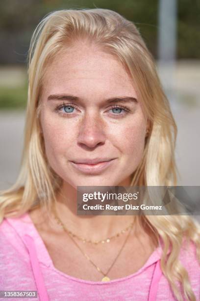 close-up of a freckle-faced woman in her 30s with light blonde hair and wide open blue eyes looking directly into the camera. - s thirtysomething stock pictures, royalty-free photos & images