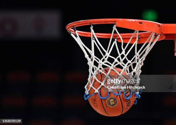 Seen is a game ball falling through the hoop netting before the start of the round two NBL match between Cairns Taipans and Tasmania Jackjumpers at...