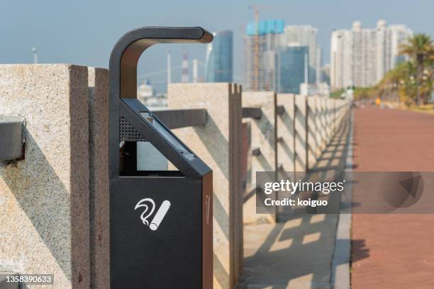 metal cigarette butts trash can on the coast - stubs stock pictures, royalty-free photos & images