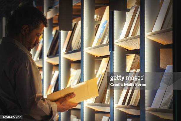 reading book in bookstore - catalogue stock pictures, royalty-free photos & images
