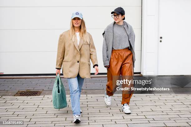 December 10: Katharina Bonmann, wearing a caramel oversized blazer by The Frankie Shop, a white crop top by Zara, wide leg jeans by Mango x Pernille...