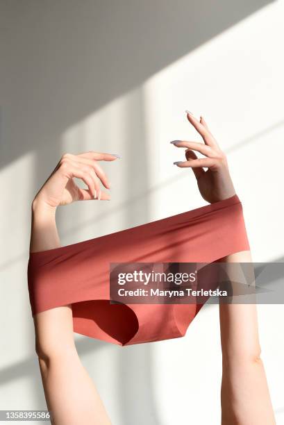 seamless female panties in the hands of the girl. - tanga imagens e fotografias de stock