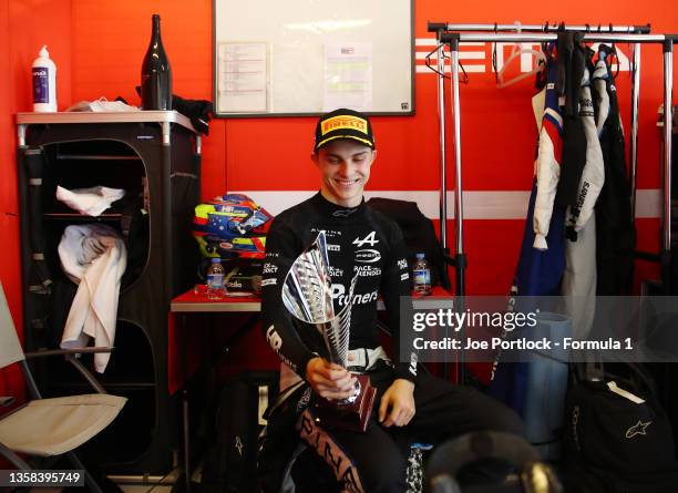 Champion Oscar Piastri of Australia and Prema Racing celebrates with his third placed trophy after sprint race 1 of Round 8:Yas Island of the Formula...