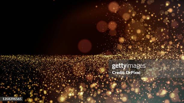 sparkling golden particles - incandescência imagens e fotografias de stock