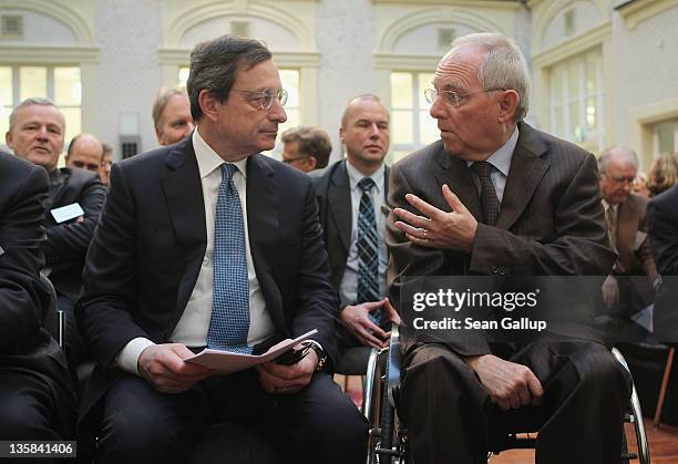 Mario Draghi , President of the European Central Bank , and German Finance Minister Wolfgang Schaeuble chat at the Ludwig Erhard Lecture on December...