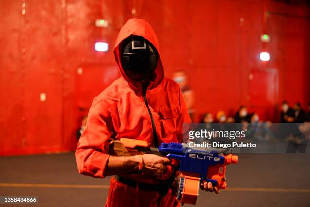 Cosplay dressed as a Guard from the squid game television series enters a cosplay contest during the 'Torino Comics' fair on December 11, 2021 in...