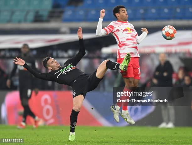 Tyler Adams of Leipzig is challenged by László Bénes of Gladbach during the Bundesliga match between RB Leipzig and Borussia Mönchengladbach at Red...