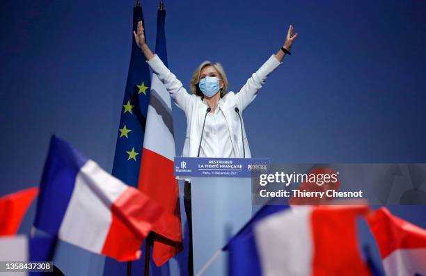 French Right-wing Presidential candidate Valerie Pecresse wearing a protective face mask acknowledges her supporters prior to a meeting following a...