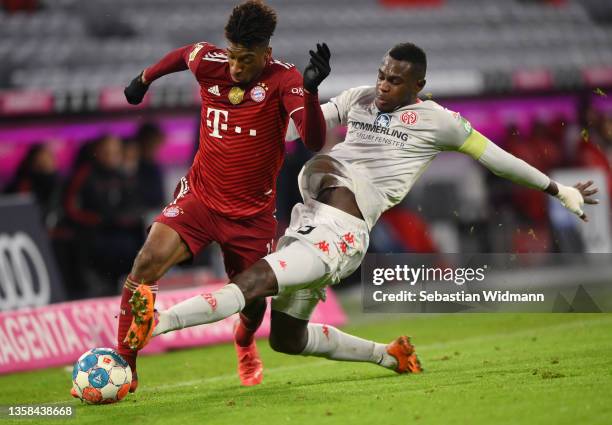 Kingsley Coman of Muenchen is challenged by Moussa Niakhate of Mainz during the Bundesliga match between FC Bayern München and 1. FSV Mainz 05 at...