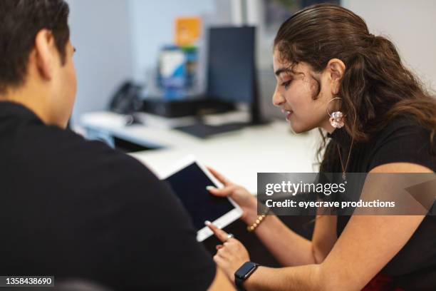 using technology mexican american male and female in business retail center working together latinx candidates photo series - mexican american stock pictures, royalty-free photos & images