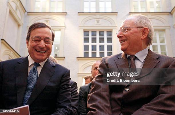 Mario Draghi, president of the European Central Bank , left, and Wolfgang Schaeuble, Germany's finance minister, react during the 'Ludwig Erhard...