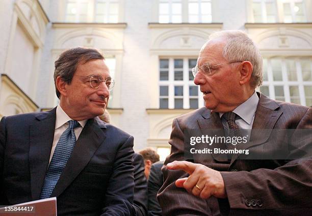 Mario Draghi, president of the European Central Bank , left, listens as Wolfgang Schaeuble, Germany's finance minister, speaks during the 'Ludwig...