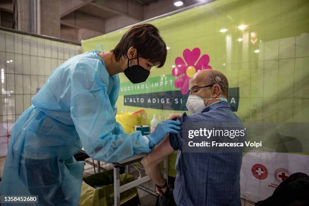 Man receiveing the vaccine, at FieraMesse, the trade fair center of Bolzano, during a Covid-19 vaccination marathon in South Tyrol, on December 11,...