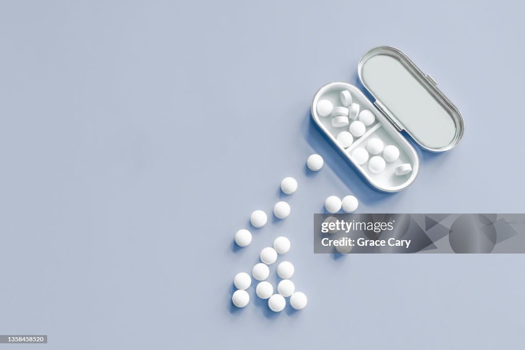 White Pills on Blue Background