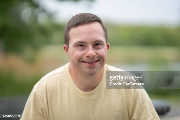 portrait of a man with down syndrome - adult stock pictures, royalty-free photos & images