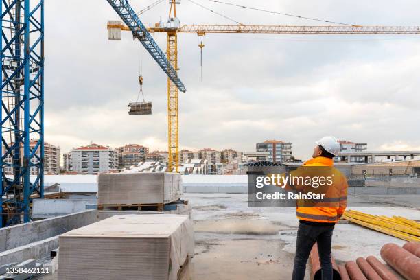 engenheiro civil e guindastes em canteiro de obras - hastear - fotografias e filmes do acervo