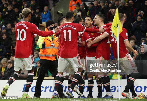 Cristiano Ronaldo of Manchester United celebrates with team mates after scoring their side's first goal during the Premier League match between...