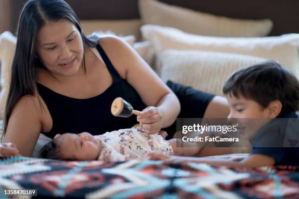 meeting the new baby - native american family stock pictures, royalty-free photos & images