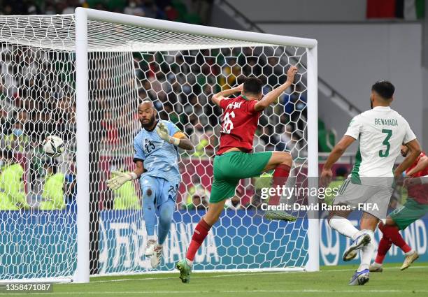 Mohammed Nahiri of Morocco scores their team's first goal past Rais Mbolhi of Algeria during the FIFA Arab Cup Qatar 2021 Quarter-Final match between...