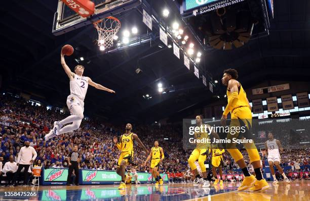 Christian Braun of the Kansas Jayhawks scores on a fast break during the game against the Missouri Tigers at Allen Fieldhouse on December 11, 2021 in...