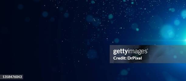 abstract defocused lights and particles with lens flare - star dust stock pictures, royalty-free photos & images