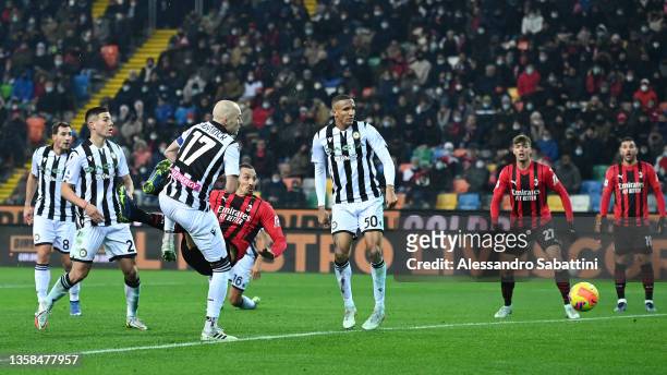 Zlatan Ibrahimovic of AC Milan scores their side's first goal during the Serie A match between Udinese Calcio and AC Milan at Dacia Arena on December...