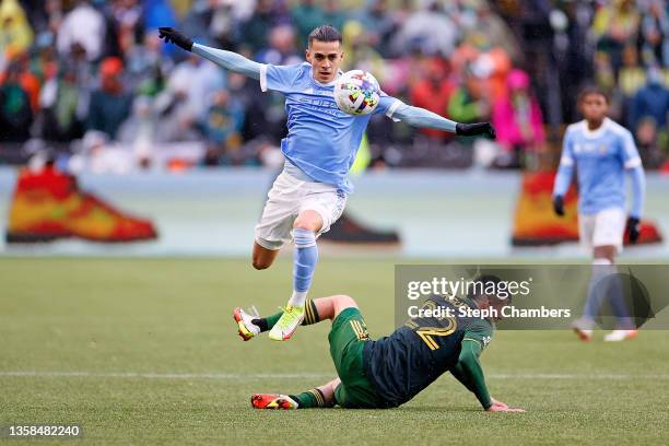 Jesus Medina of New York City jumps over Cristhian Paredes of Portland Timbers while dribbling downfield during the second half of the 2021 MLS Cup...