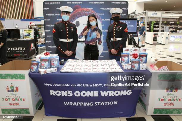 Kylie Cantrall and members of the US Marines attend the 20th Century Studios and Locksmith Animation RON'S GONE WRONG holiday gift wrapping event,...
