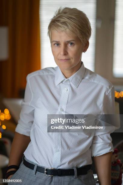 a homosexual woman with short hair looks at camera - businesswear stock pictures, royalty-free photos & images