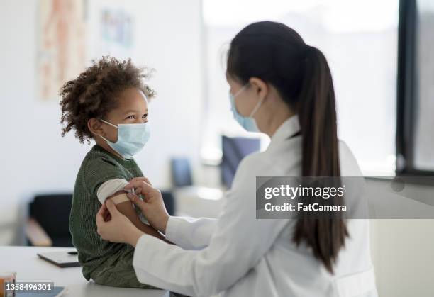 getting a bandage after a vaccine - vaccination bildbanksfoton och bilder